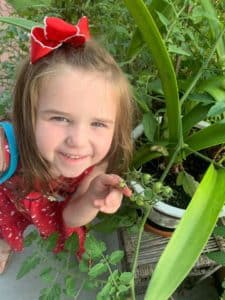 anna-little-girl-with-a-tomato-plant