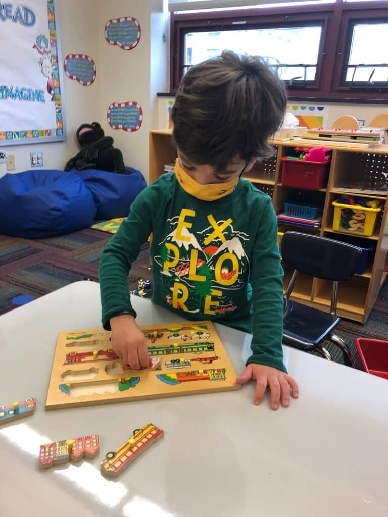 SAILL Preschool, doing a puzzle