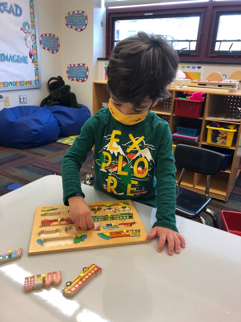 SAILL Preschool, doing a puzzle