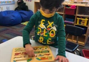 SAILL Preschool, doing a puzzle